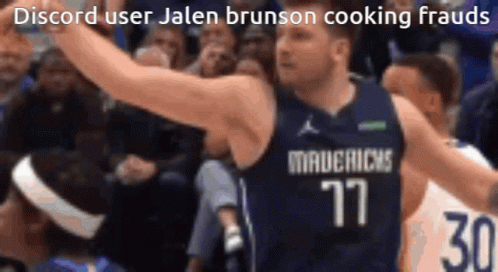 A Basketball Player In A Mavericks Jersey Celebrates With His Arms In The Air . GIF