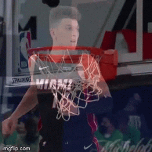 A Basketball Player In A Miami Jersey Is Holding A Basketball Net GIF