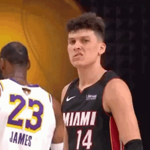 A Basketball Player In A Miami Jersey Is Standing Next To Another Player In A White Jersey . GIF