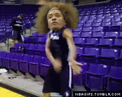 a basketball player in a purple uniform is dancing