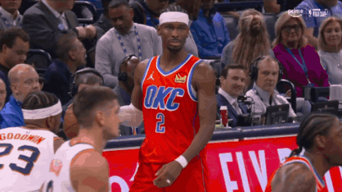 a basketball player in a red okc jersey