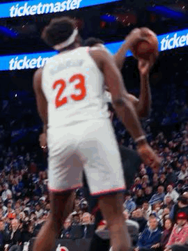 A Basketball Player In A White Jersey With The Number 23 On It Is Holding A Basketball In His Hand . GIF