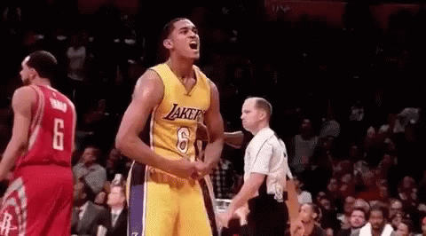 A Basketball Player In A Yellow Jersey Is Standing In Front Of A Referee . GIF