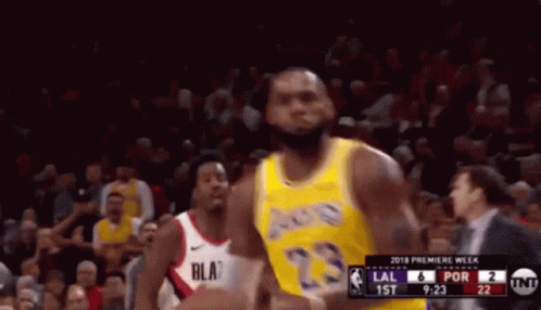 A Basketball Player In A Yellow Jersey With The Number 23 GIF