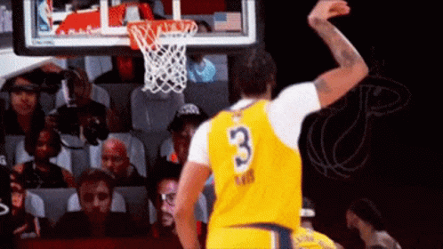 A Basketball Player In A Yellow Jersey With The Number 3 On It Is Jumping In The Air . GIF
