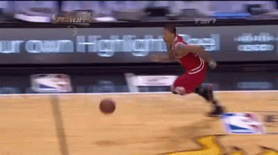 A Basketball Player Is Dribbling A Ball On A Court With A Sign That Says Iron Heights In The Background GIF