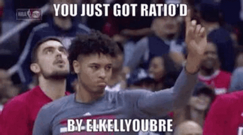 a basketball player is giving a high five to a crowd of people .