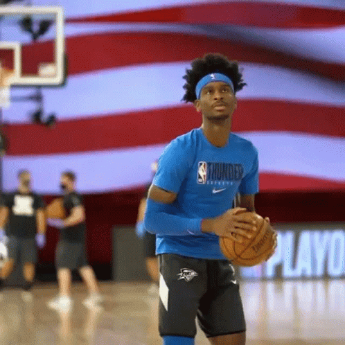 A Basketball Player Is Holding A Basketball On A Basketball Court . GIF