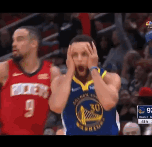 A Basketball Player Is Holding His Head In His Hands While Another Basketball Player Looks On . GIF