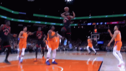A Basketball Player Is Jumping In The Air During A Game Against The Suns GIF