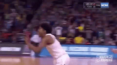 A Basketball Player Is Jumping In The Air During A Game Sponsored By Ncaa GIF