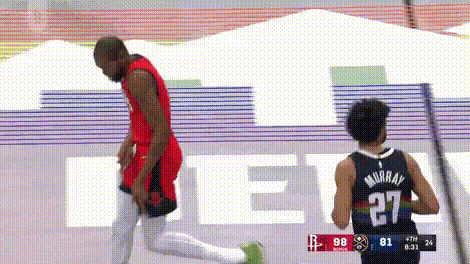 A Basketball Player Is Kneeling Down Next To Another Player On A Court . GIF