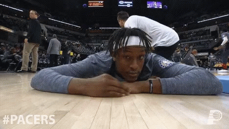 A Basketball Player Is Laying On The Floor With #Pacers Written In The Corner GIF