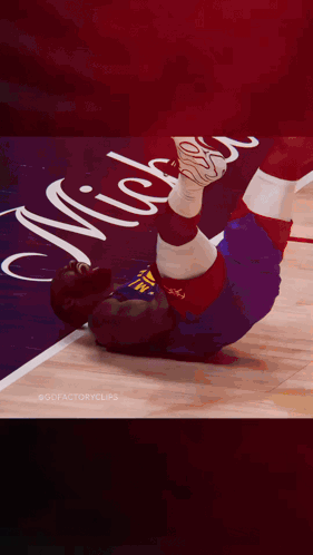 a basketball player is laying on the floor with the number 11 on his shirt