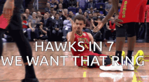 A Basketball Player Is Laying On The Floor With The Words " Hawks In 7 We Want That Ring " Behind Him GIF