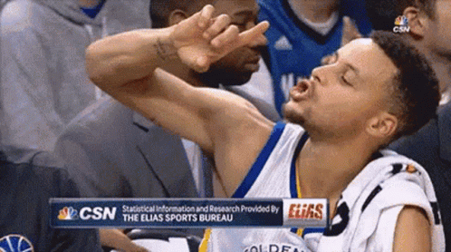 A Basketball Player Is Making A Funny Face In The Stands During A Game . GIF