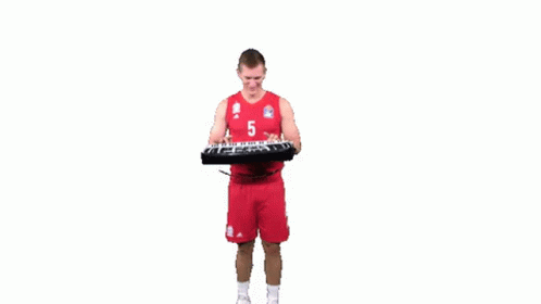 A Basketball Player Is Playing A Keyboard While Wearing A Number 5 Jersey . GIF