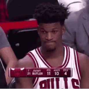 A Basketball Player Is Sitting In The Stands During A Game And Holding A Scoreboard . GIF