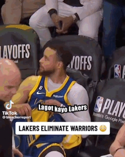 A Basketball Player Is Sitting In The Stands During A Game And Talking To Someone . GIF