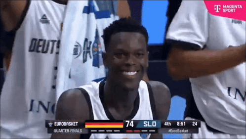 A Basketball Player Is Smiling In Front Of A T-Mobile Ad GIF