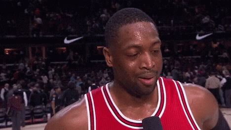 A Basketball Player Is Sweating And Talking Into A Microphone . GIF