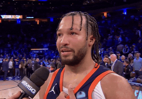 A Basketball Player Is Talking Into A Microphone That Says Msc On It GIF