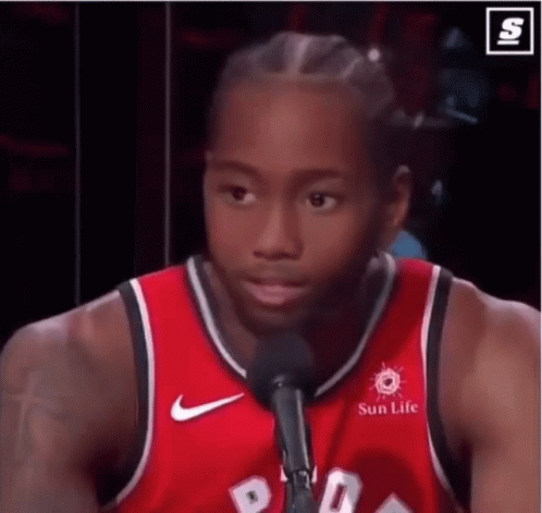 A Basketball Player Is Talking Into A Microphone While Wearing A Red Jersey That Says Sun Life . GIF