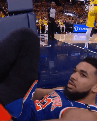A Basketball Player Laying On The Floor Wearing A Jersey With The Number 45 GIF