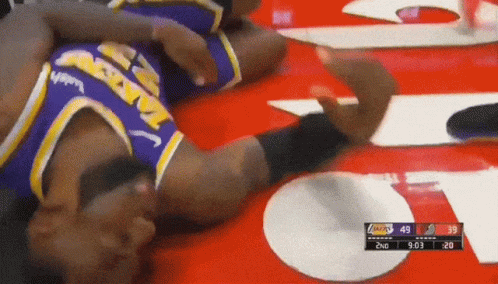 A Basketball Player Laying On The Floor With A Score Of 49 To 39 GIF