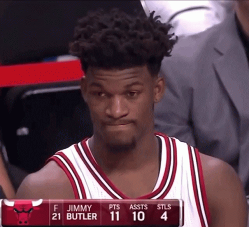 A Basketball Player Named Jimmy Butler Is Sitting On The Bench GIF
