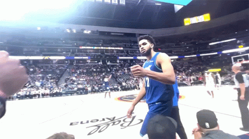 A Basketball Player Stands In Front Of A Ball Arena Sign GIF