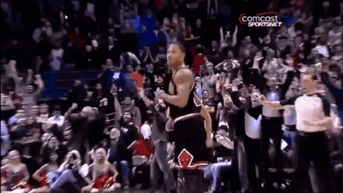 A Basketball Player Stands In Front Of A Crowd With A Comcast Sportsnet Logo GIF