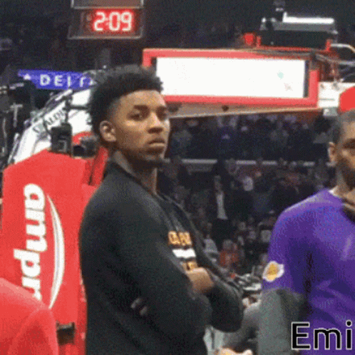 A Basketball Player Stands In Front Of A Scoreboard That Says 2.09 GIF