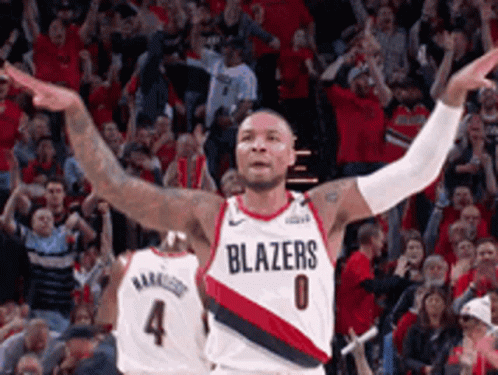 A Basketball Player Wearing A Blazers Jersey Is Celebrating GIF