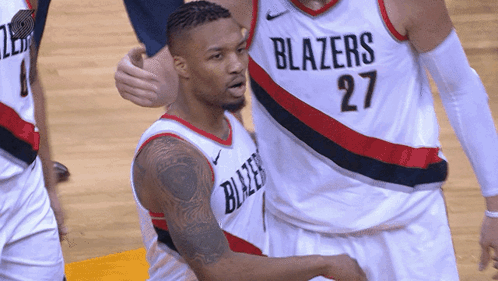 a basketball player wearing a blazers jersey number 27