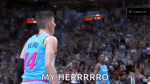 A Basketball Player Wearing A Blue And Pink Jersey With The Number 14 On It GIF