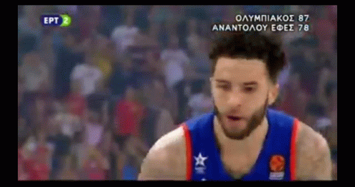 A Basketball Player Wearing A Blue And Red Jersey With A Star On It Is Standing On A Court . GIF