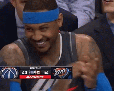 A Basketball Player Wearing A Blue Headband Is Smiling In Front Of A Scoreboard That Says Halftime At The Top GIF