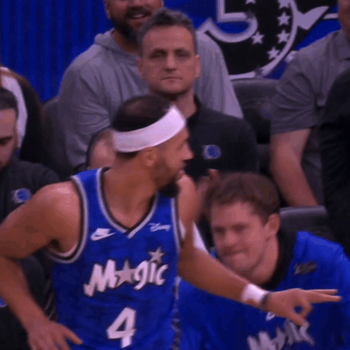 A Basketball Player Wearing A Blue Jersey That Says Magic On It GIF