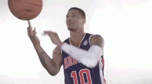 A Basketball Player Wearing A Blue Jersey With The Number 10 On It Is Spinning A Basketball On His Finger . GIF
