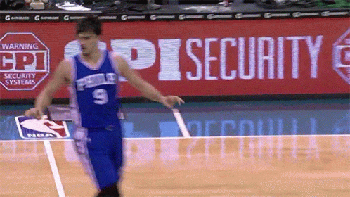 A Basketball Player Wearing A Blue Jersey With The Number 9 GIF