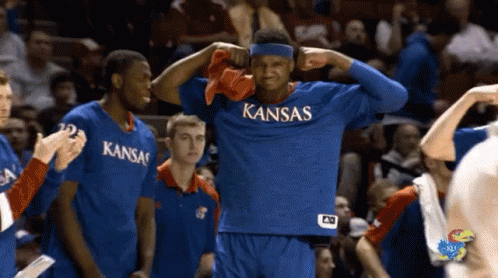 A Basketball Player Wearing A Blue Kansas Jersey GIF