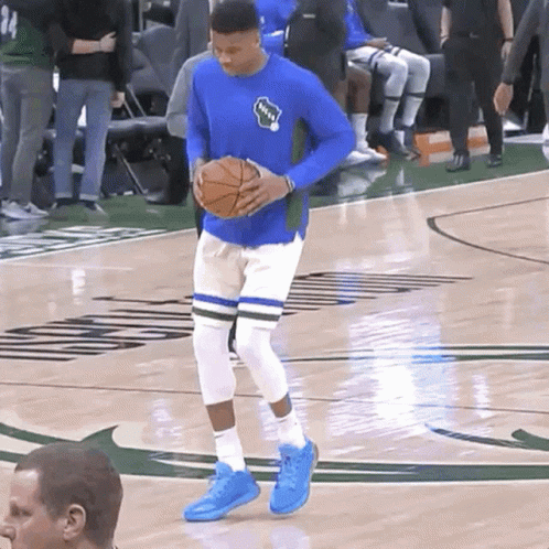 A Basketball Player Wearing A Blue Shirt That Says Bucks On It GIF
