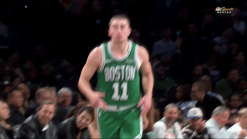 A Basketball Player Wearing A Boston 11 Jersey Stands In Front Of A Crowd GIF