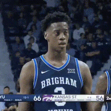 A Basketball Player Wearing A Brigham Jersey Is Standing On The Court . GIF