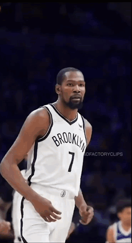 A Basketball Player Wearing A Brooklyn Nets Jersey Is Standing On The Court . GIF