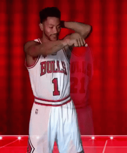 A Basketball Player Wearing A Bulls Jersey And Shorts Is Dancing On A Stage . GIF
