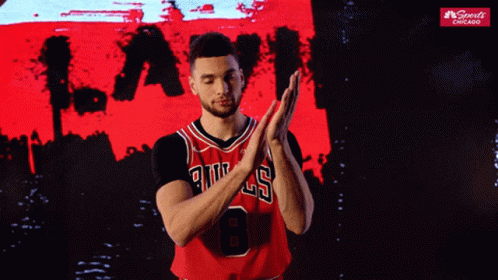 A Basketball Player Wearing A Bulls Jersey Clapping His Hands GIF