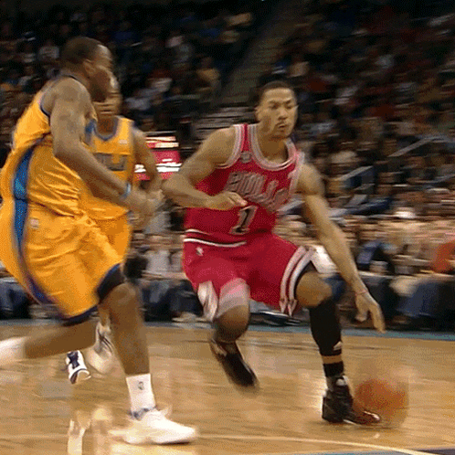 A Basketball Player Wearing A Bulls Jersey Dribbles A Ball GIF