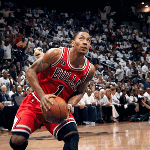 A Basketball Player Wearing A Bulls Jersey Holds A Basketball GIF